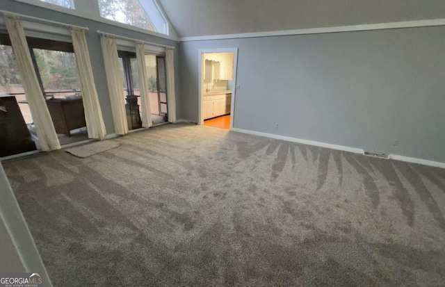 spare room featuring carpet and lofted ceiling