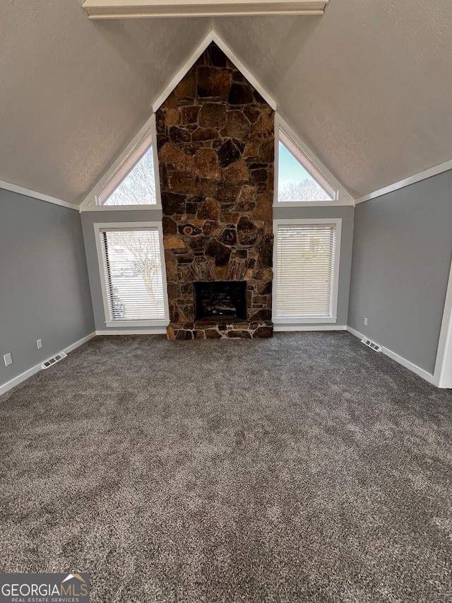 unfurnished living room featuring crown molding, a fireplace, high vaulted ceiling, and carpet flooring