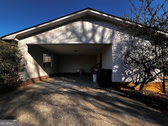 view of home's exterior with aphalt driveway