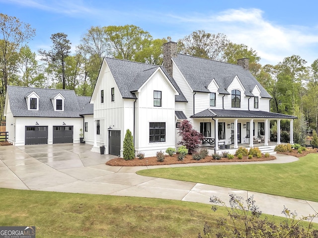 modern farmhouse with a front lawn and a porch