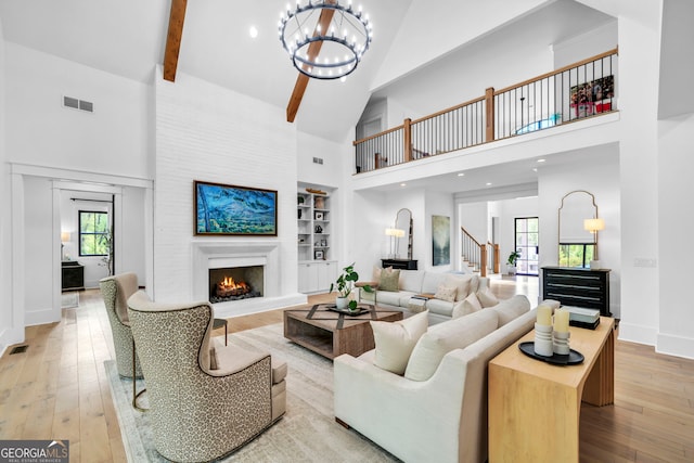 living room featuring wood-type flooring, a healthy amount of sunlight, and built in features