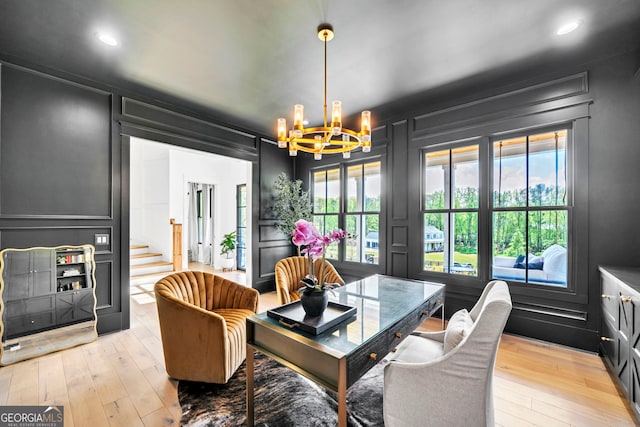 dining area with a notable chandelier and light wood-type flooring