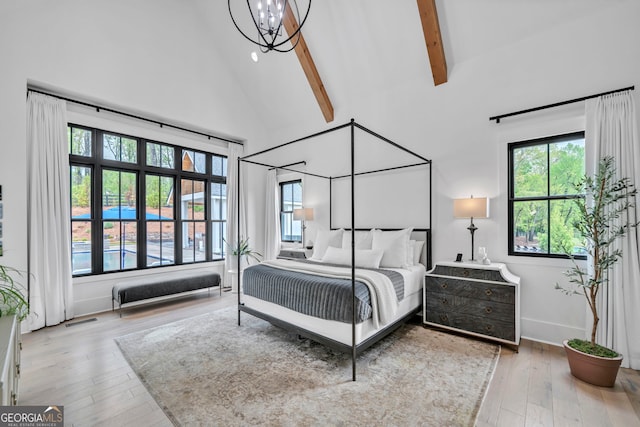 bedroom featuring beamed ceiling, wood-type flooring, high vaulted ceiling, and a notable chandelier