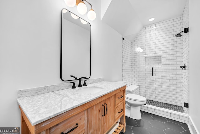 bathroom featuring lofted ceiling, toilet, vanity, a shower with door, and tile patterned flooring