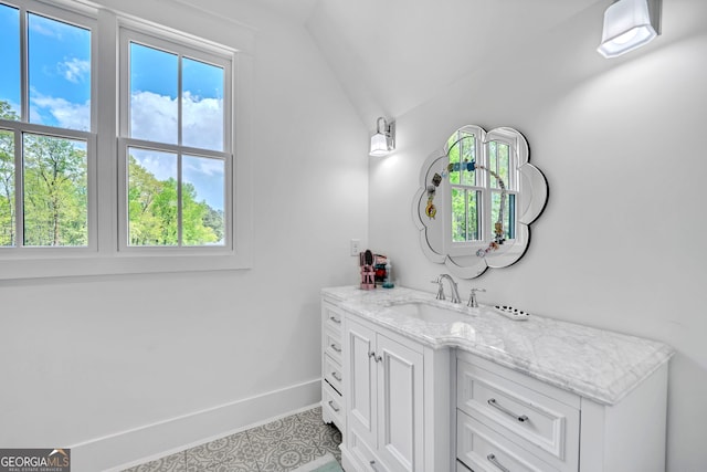 bathroom featuring vanity and lofted ceiling