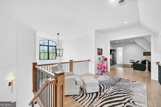 living area featuring a chandelier and light wood-type flooring