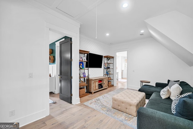 living room featuring crown molding and light hardwood / wood-style flooring