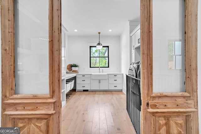 bathroom with vanity, hardwood / wood-style floors, and washer and clothes dryer