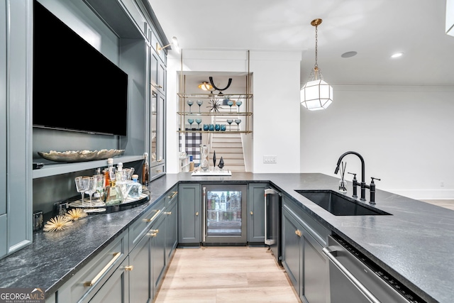 kitchen featuring decorative light fixtures, sink, beverage cooler, ornamental molding, and stainless steel dishwasher