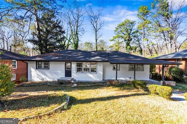 view of front of property with a carport and a front lawn