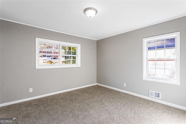 carpeted spare room with crown molding