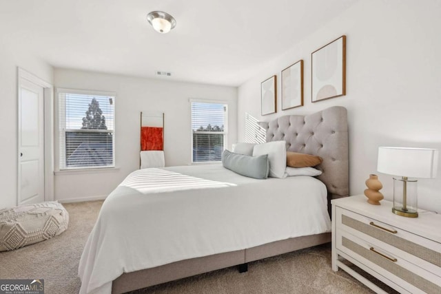 bedroom with multiple windows and carpet flooring