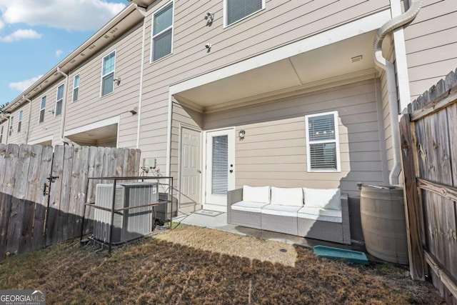 rear view of property with an outdoor hangout area and central air condition unit