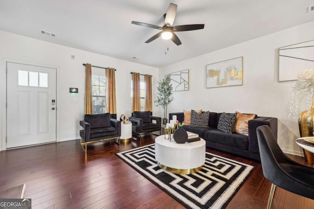 living room featuring ceiling fan and dark hardwood / wood-style floors