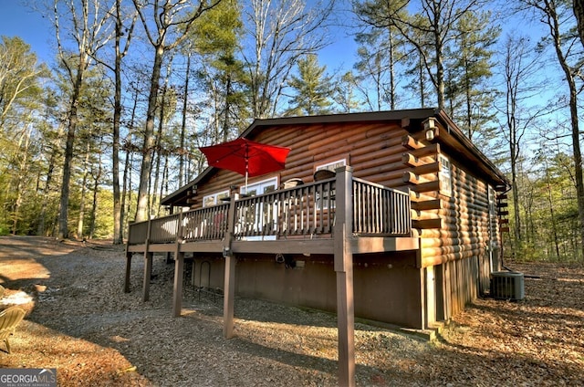 back of property featuring central AC and a deck