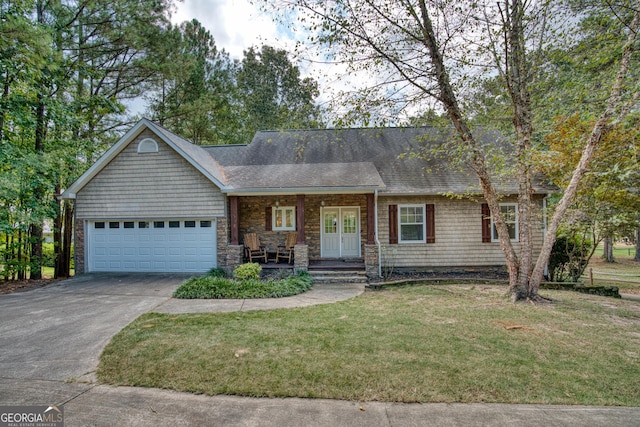 single story home featuring a porch, a garage, and a front yard