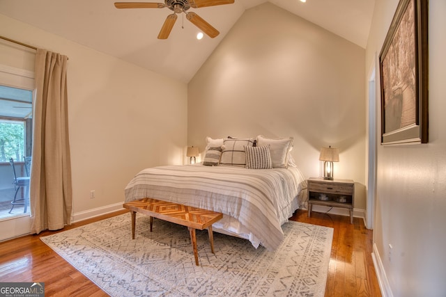 bedroom with ceiling fan, wood-type flooring, and vaulted ceiling