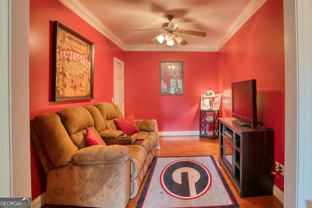 living room featuring ornamental molding, wood-type flooring, and ceiling fan