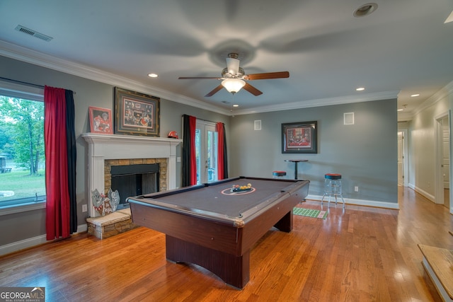 game room with billiards, crown molding, ceiling fan, a fireplace, and light hardwood / wood-style floors