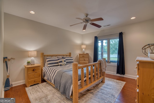 bedroom with ceiling fan and dark hardwood / wood-style flooring