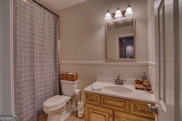 bathroom featuring vanity, tile patterned flooring, and toilet