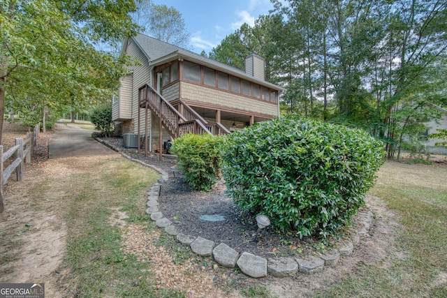 exterior space with cooling unit and a sunroom