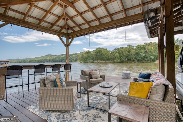 view of dock featuring a gazebo, outdoor lounge area, and a water view