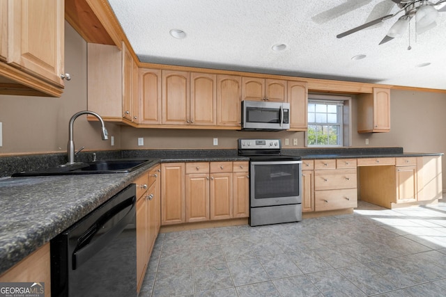 kitchen with light brown cabinetry, sink, stainless steel appliances, and a textured ceiling