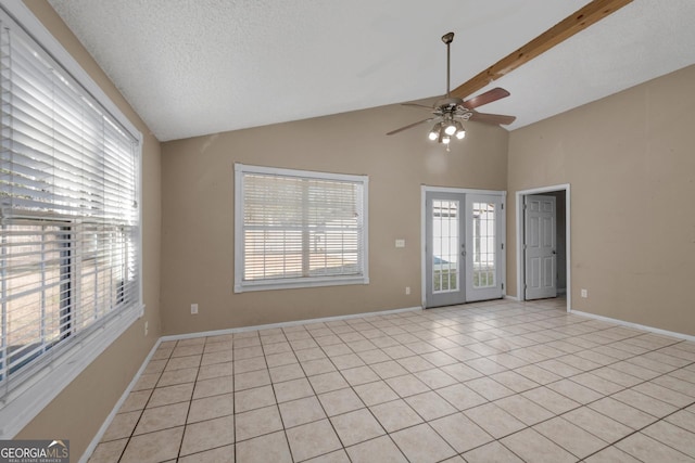 spare room with light tile patterned floors, lofted ceiling with beams, and a wealth of natural light