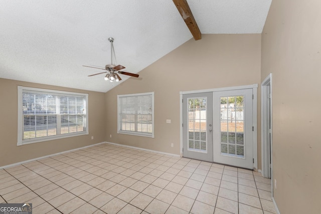 tiled empty room featuring french doors, plenty of natural light, a textured ceiling, and vaulted ceiling with beams