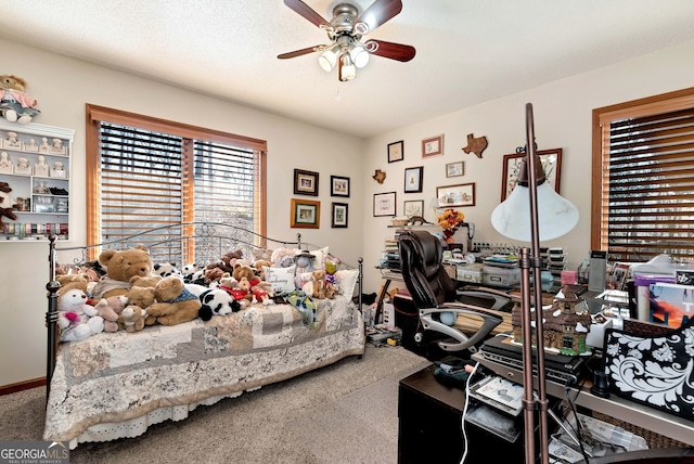 carpeted bedroom featuring a textured ceiling and ceiling fan