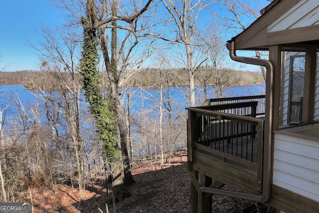 wooden terrace featuring a water view