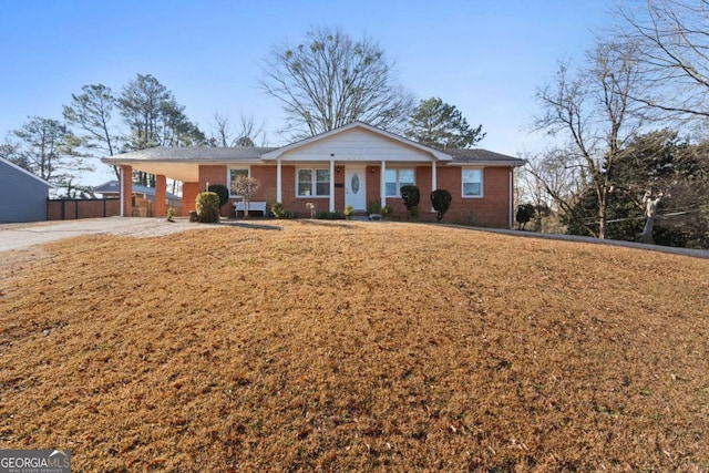 ranch-style home featuring a carport and a front lawn