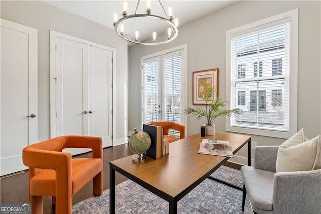 living area featuring a notable chandelier and hardwood / wood-style flooring