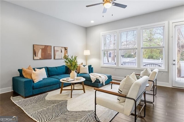 living room with ceiling fan and dark hardwood / wood-style flooring