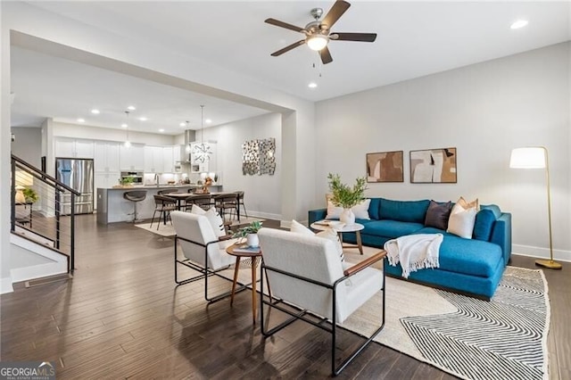 living room featuring dark hardwood / wood-style floors and ceiling fan