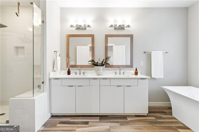 bathroom with hardwood / wood-style flooring, vanity, and independent shower and bath