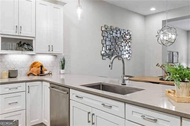 kitchen featuring dishwasher, white cabinetry, sink, and pendant lighting