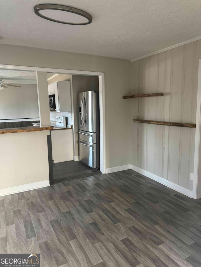 kitchen featuring stainless steel refrigerator with ice dispenser, range with electric cooktop, a textured ceiling, and dark hardwood / wood-style flooring