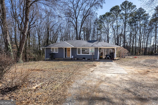 ranch-style home featuring a carport