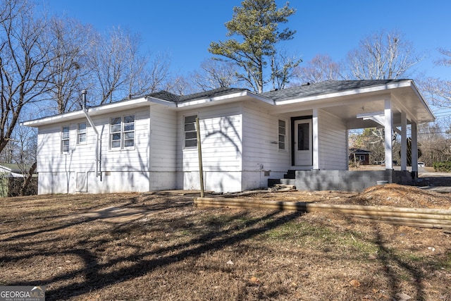 rear view of house with a porch