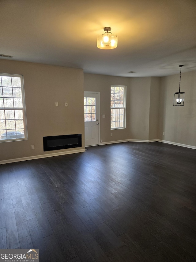 unfurnished living room featuring dark hardwood / wood-style flooring