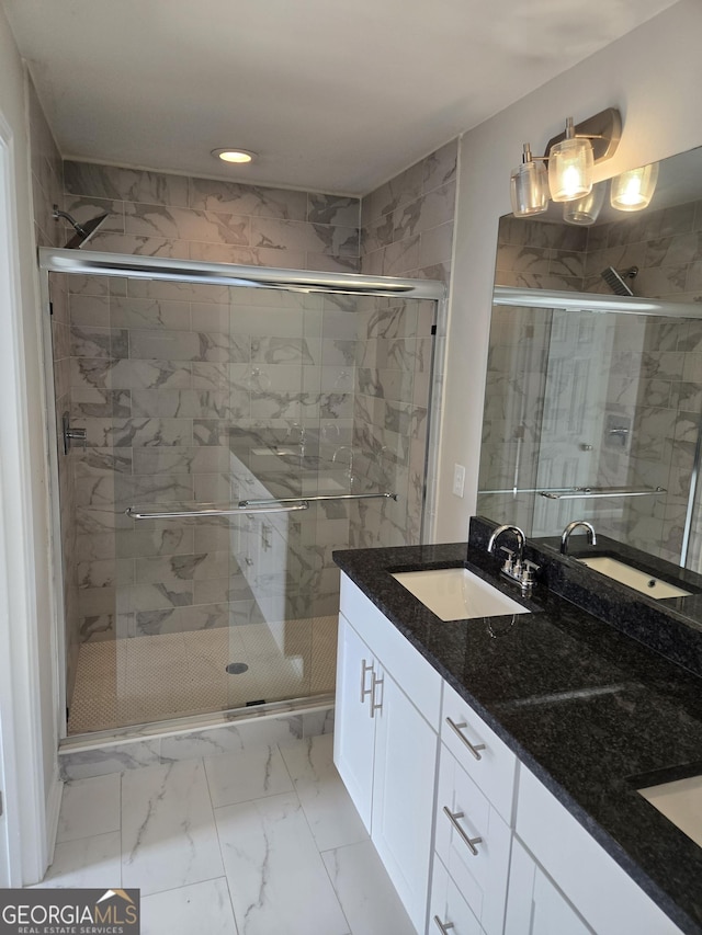 bathroom with a shower with door and vanity