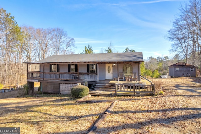 view of front of property with a storage shed and covered porch