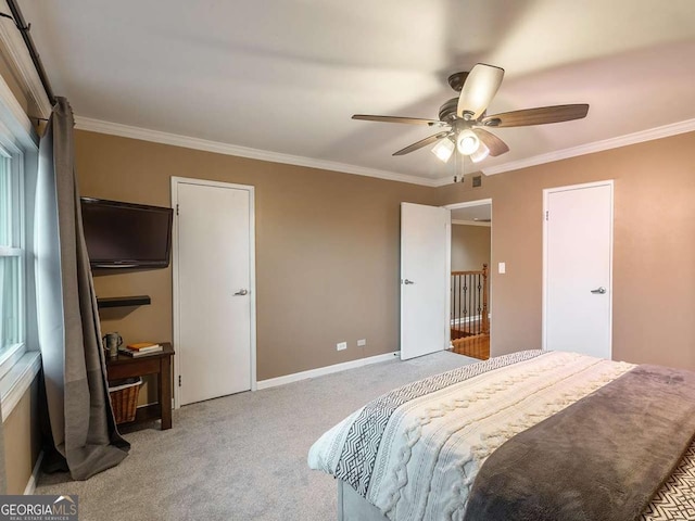 bedroom with carpet flooring, a ceiling fan, baseboards, and ornamental molding