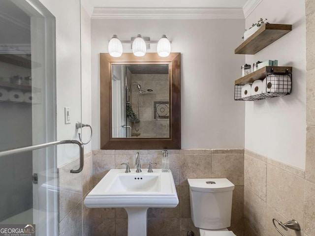 full bathroom featuring a stall shower, toilet, tile walls, and ornamental molding