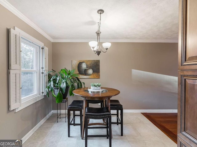 dining room with an inviting chandelier, crown molding, and baseboards