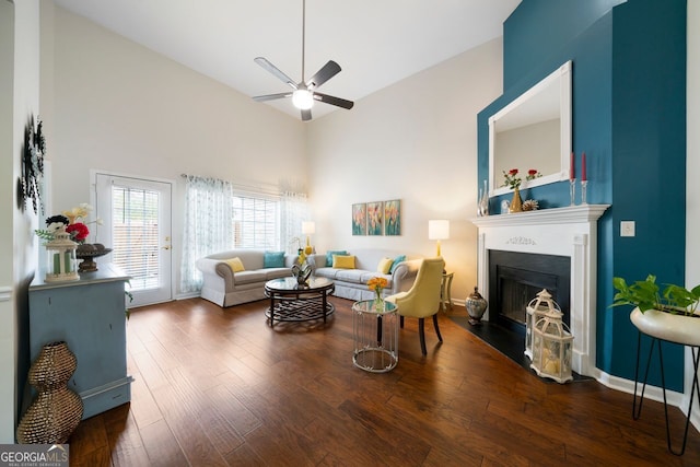 living room with ceiling fan, dark hardwood / wood-style flooring, and high vaulted ceiling