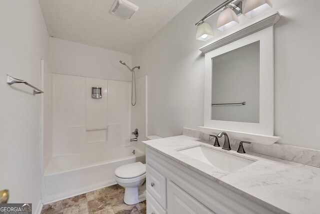 full bathroom featuring shower / bathing tub combination, vanity, a textured ceiling, and toilet