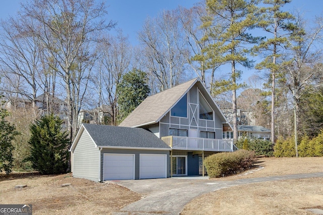 view of front of property featuring a garage and a balcony